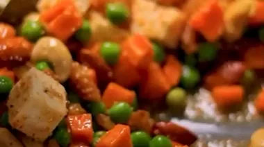 Phulkari Pulao with saffron rice, nuts, peas, and paneer served in a brass bowl 4